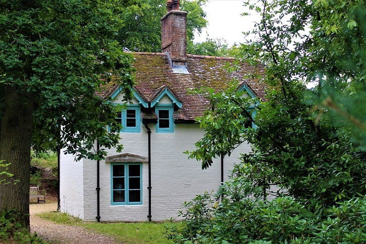 The white walls of Clouds Hill through the trees.