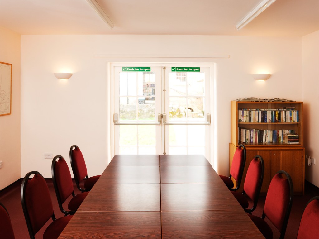 Diamond Jubilee room with double doors onto small outdoor courtyard.